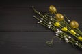 Decorative willow twigs with Easter eggs on a wooden background