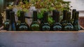 Decorative wine bottles in a gray wooden box.