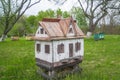 Decorative wooden beehives at apiary. Bee hive in village green garden Royalty Free Stock Photo