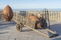 Decorative wooden cart with earthenware jug stands on a shore near the sea water in Batumi, Georgia Royalty Free Stock Photo