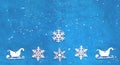 Decorative wooden Christmas snowflakes and sleighs on blue background. Festive New Year card in trendy color Royalty Free Stock Photo