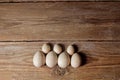 Decorative wooden eggs laid out in an unusual way on a rustic table. symbolic holiday composition for gift card. copy space. close