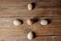 Decorative wooden eggs laid out in an unusual way on a rustic table. symbolic holiday composition for gift card. copy space. close