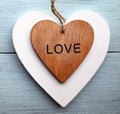 Decorative wooden hearts on a blue wooden background.Two Valentine hearts.Saint Valentine`s Day or Love concept. Royalty Free Stock Photo