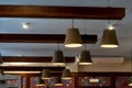 A decorative wooden lampshade with an energy-saving diode lamp is hanging from the ceiling. Unusual designer chandeliers made of
