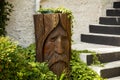 Decorative wooden log carved into an old man`s face Royalty Free Stock Photo