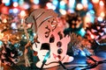 Decorative wooden snowman against the backdrop of blurred christmas lights and other seasonal decorations Royalty Free Stock Photo