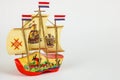 Decorative wooden toys boat, dutch boot-boat on white background. Place for text. Selective focus. Horizontal image