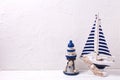 Decorative wooden toys boat and lighthouse on textured white