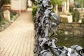 Decorative wrought iron pond fence in the park. Selective focus