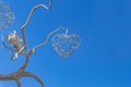 Decorative wrought iron wood with flower and heart openwork on a background of blue sky Royalty Free Stock Photo