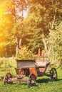 Decorative Yard Wagon On Summer Lawn. Bright Sunny Day. Gardening And Housekeeping. Vintage Cart On Summer Sunny Day Royalty Free Stock Photo