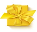 Decorative yellow gift box with yellow bow isolated on white. Gift wrapping design template. Top view. Flat lay. Royalty Free Stock Photo