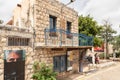 Decoratively decorated facade of a stone building with a balcony in the famous artists village Ein Hod near Haifa in northern