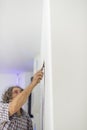 Decorator retouching imperfections in a wall