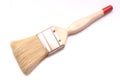 A decorator`s paint brush with beige colored handle