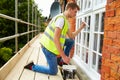 Decorator On Scaffolding Painting Exterior House Windows Royalty Free Stock Photo