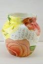 Decoupage decorated flower pattern jar on wooden background