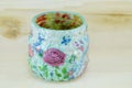 Decoupage decorated flower pattern jar on wooden background