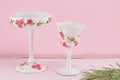 Decoupage decorated wine glasses against pink background