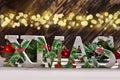 decoupage decorated XMAS letters on wooden background with bokeh effect