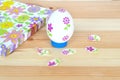 Decoupage Easter egg, napkins with a floral pattern on a natural wooden background Royalty Free Stock Photo