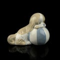 Antique figurine of a dog on a black isolated background. puppy toy. Royalty Free Stock Photo