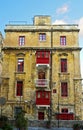 Decrepit house with new red windows