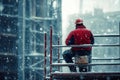 Dedicated construction worker braving cold winter weather at a high rise building site Royalty Free Stock Photo