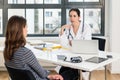 Dedicated doctor listening to her patient during a private consultation Royalty Free Stock Photo