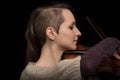 Dedicated female violinist playing baroque violin