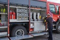 A dedicated firefighter preparing a modern firetruck for deployment to hazardous fire-stricken areas, demonstrating