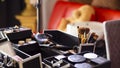 Dedicated focus Make-up converter on makeup artist's table with lots of makeup artist tools Royalty Free Stock Photo