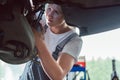 Dedicated mechanic working in a modern automobile repair shop