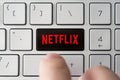 Dedicated Netflix key on computer keyboard, concept picture of global communications and modern TV streaming