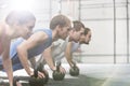 Dedicated people doing pushups with kettlebells at crossfit gym Royalty Free Stock Photo
