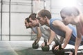 Dedicated people doing pushups with kettlebells at crossfit gym Royalty Free Stock Photo