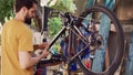 Dedicated people reparing modern bicycle