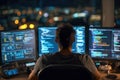 Dedicated Programmer Surrounded by Technology at Night Royalty Free Stock Photo