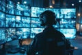 Focused Security Operator Monitoring Multiple Surveillance Screens in a Control Center with Blue Lighting and High-Tech Equipment