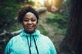 Dedicated to get fit. Portrait of a sporty young woman ready to workout in the forest.