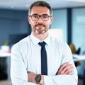 Dedicated to his business. Shot of a mature businessman standing with his arms crossed crossed in an office at work. Royalty Free Stock Photo