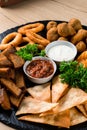 Deef Fried Fresh Beer Plate with Chicken Nuggets, Cheese Fingers, Onion Rings, Sauce on wood table. Royalty Free Stock Photo