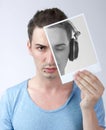 Deejay holding photo with himself Royalty Free Stock Photo