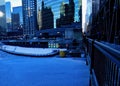 Deep blue winter morning in Chicago alongside a frozen river and elevated bridge. Royalty Free Stock Photo