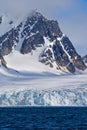 Deep Blue Glacier and Snowcapped Mountains, Albert I Land, Norway Royalty Free Stock Photo