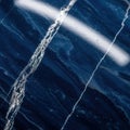 Deep blue marble texture with white veining and light reflection Royalty Free Stock Photo
