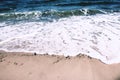 Deep blue ocean waves roll onto the sandy shore Royalty Free Stock Photo