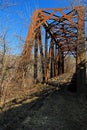 Deep blue skies over a rusted train bridge