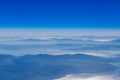 Deep blue sky above landscape with mountains and sea